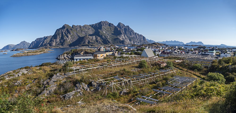 a scenic view of a small town with mountains in the background