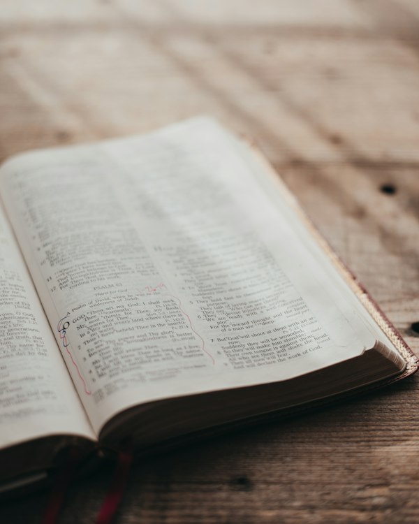 An open Bible on a wooden table