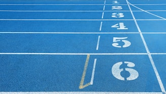 a blue running track with white numbers on it