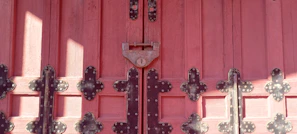 Classic paneled door painted in deep red, set against a cozy home entrance
