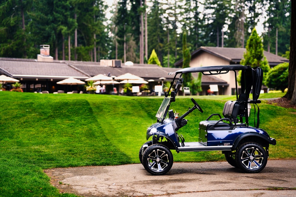 a blue golf cart parked in front of a house