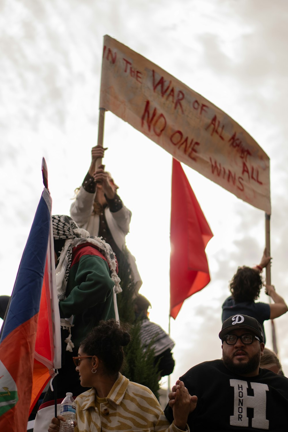 a group of people holding flags and signs