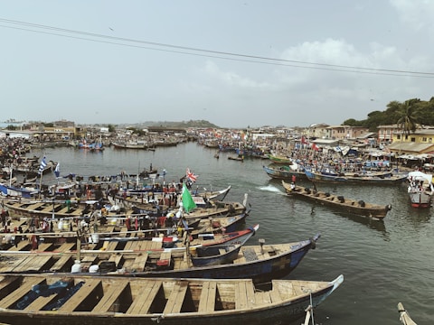 A bustling fishing port at dawn with boats unloading fresh catch.