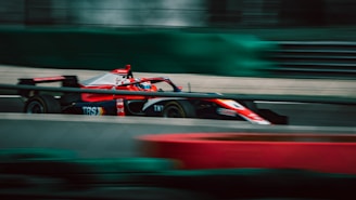 a man driving a race car on a track