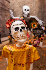 a statue of a woman with a skull on her head