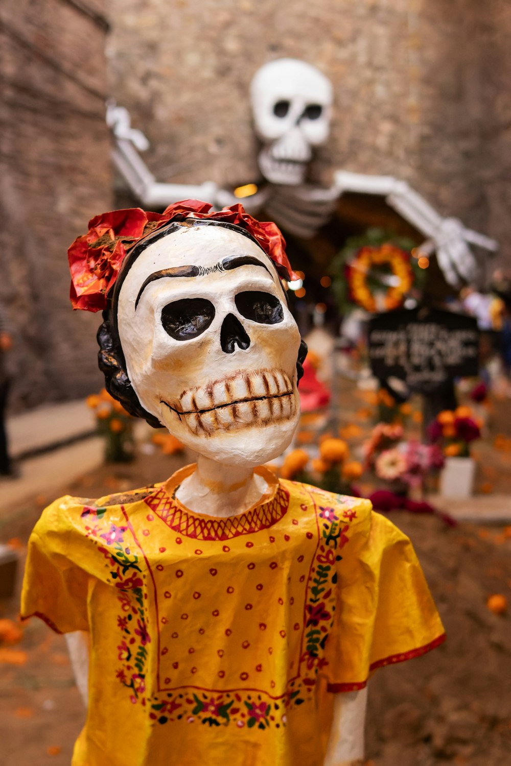 a statue of a woman with a skull on her head