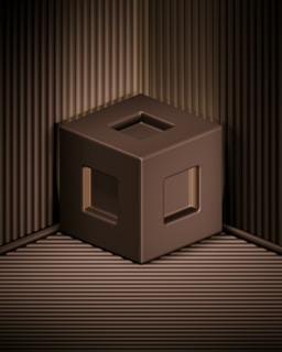 A 3D-rendered brown cube with hollow square openings on its faces is positioned against a backdrop of ribbed, metallic brown panels. The cube appears to be floating above the base surface, casting subtle shadows that create depth. The overall appearance is minimalistic and geometric.