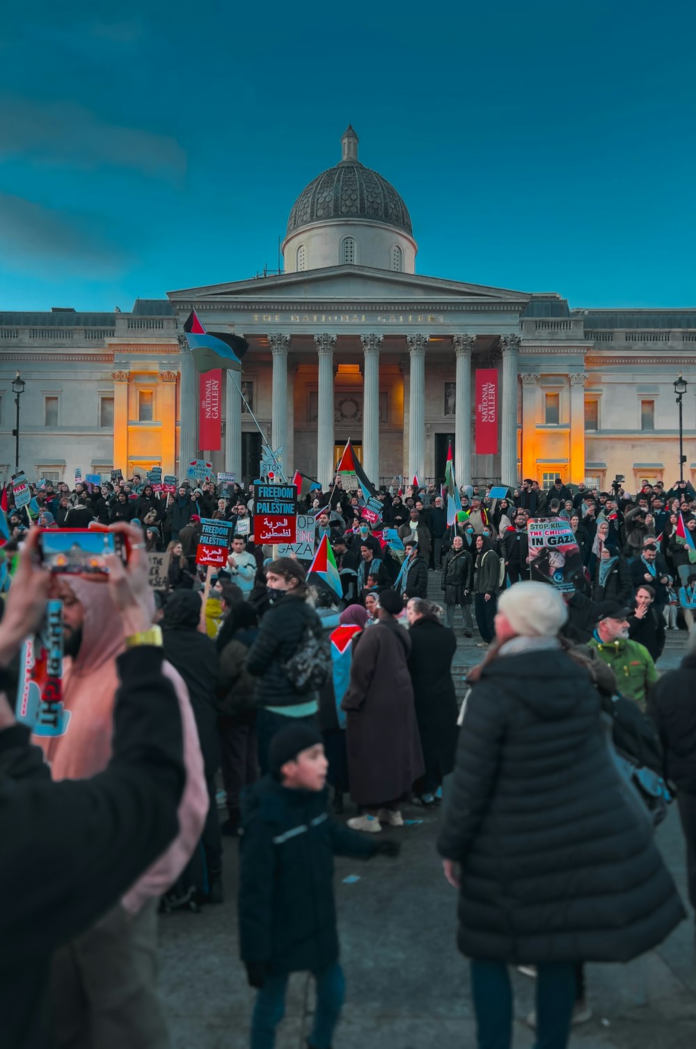 a crowd of people standing in front of a building