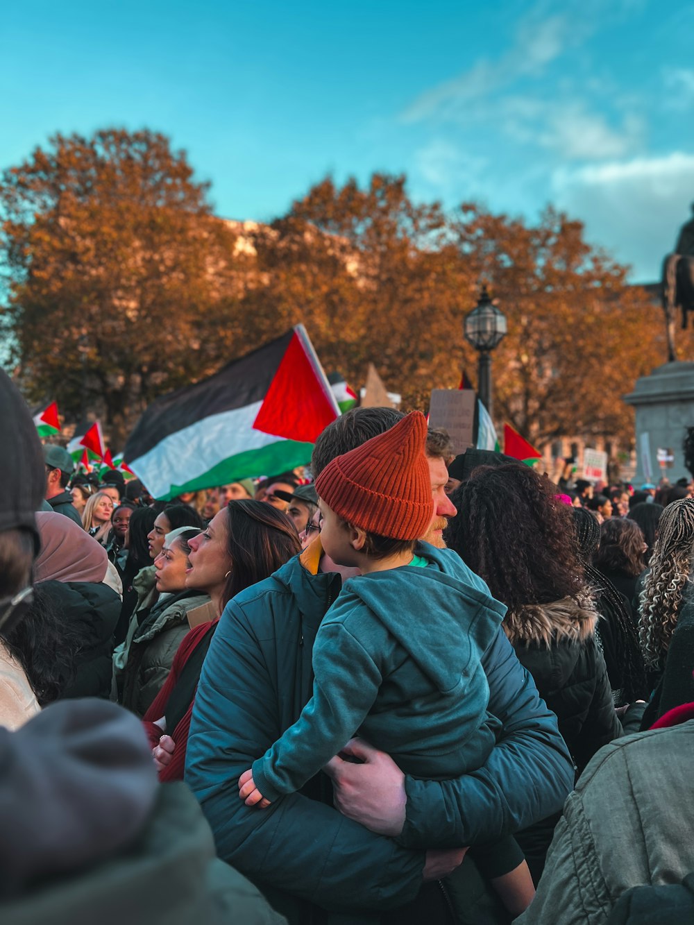 a crowd of people standing around each other