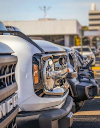 a row of parked cars in a parking lot