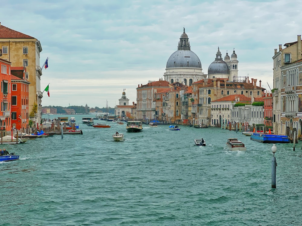 a view of a canal with boats and buildings in the background