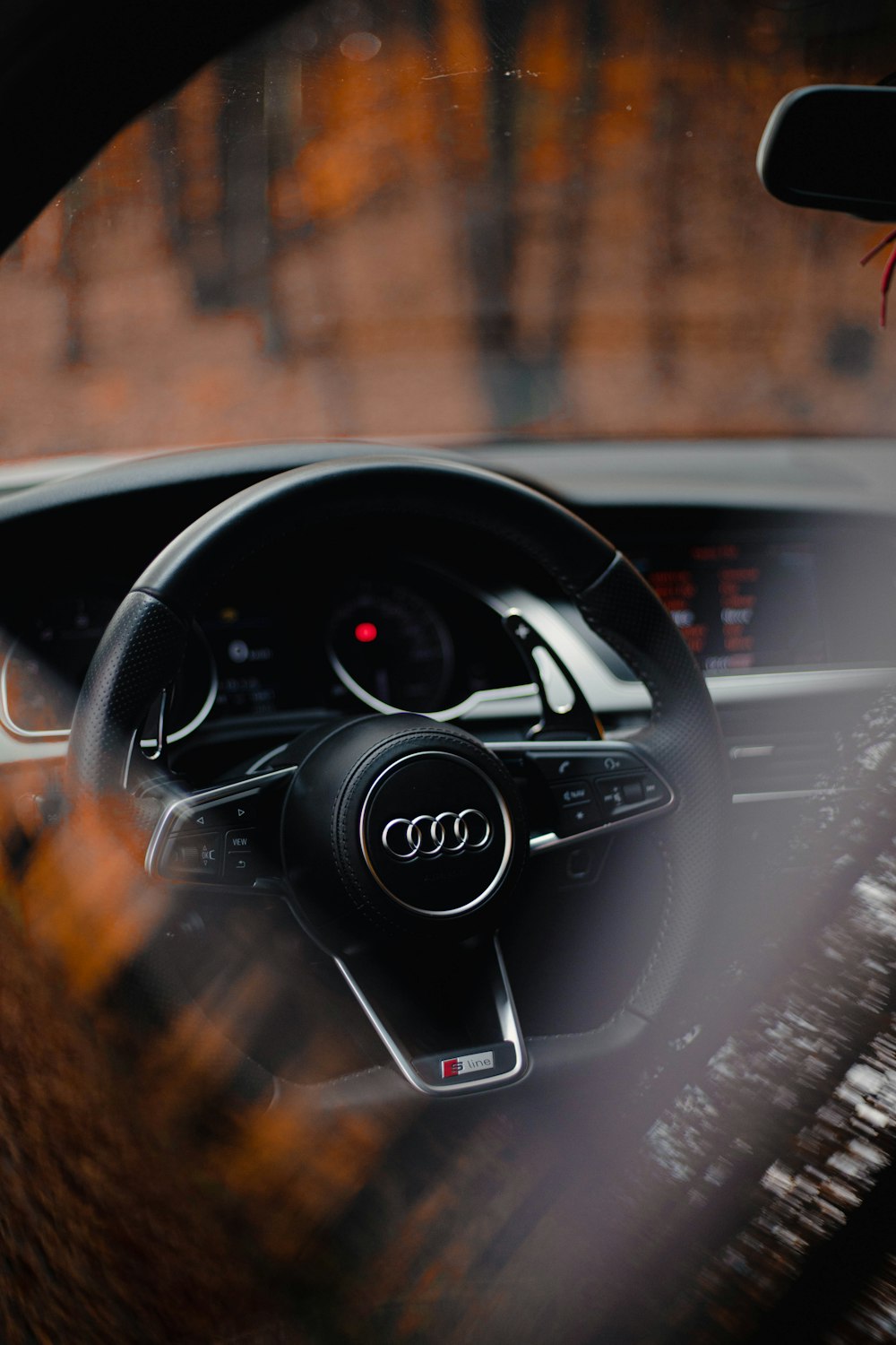 the interior of a car with a steering wheel and dashboard