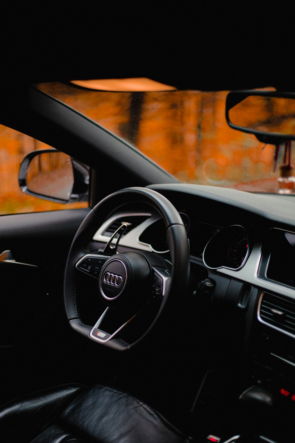 the interior of a car with a steering wheel and dashboard