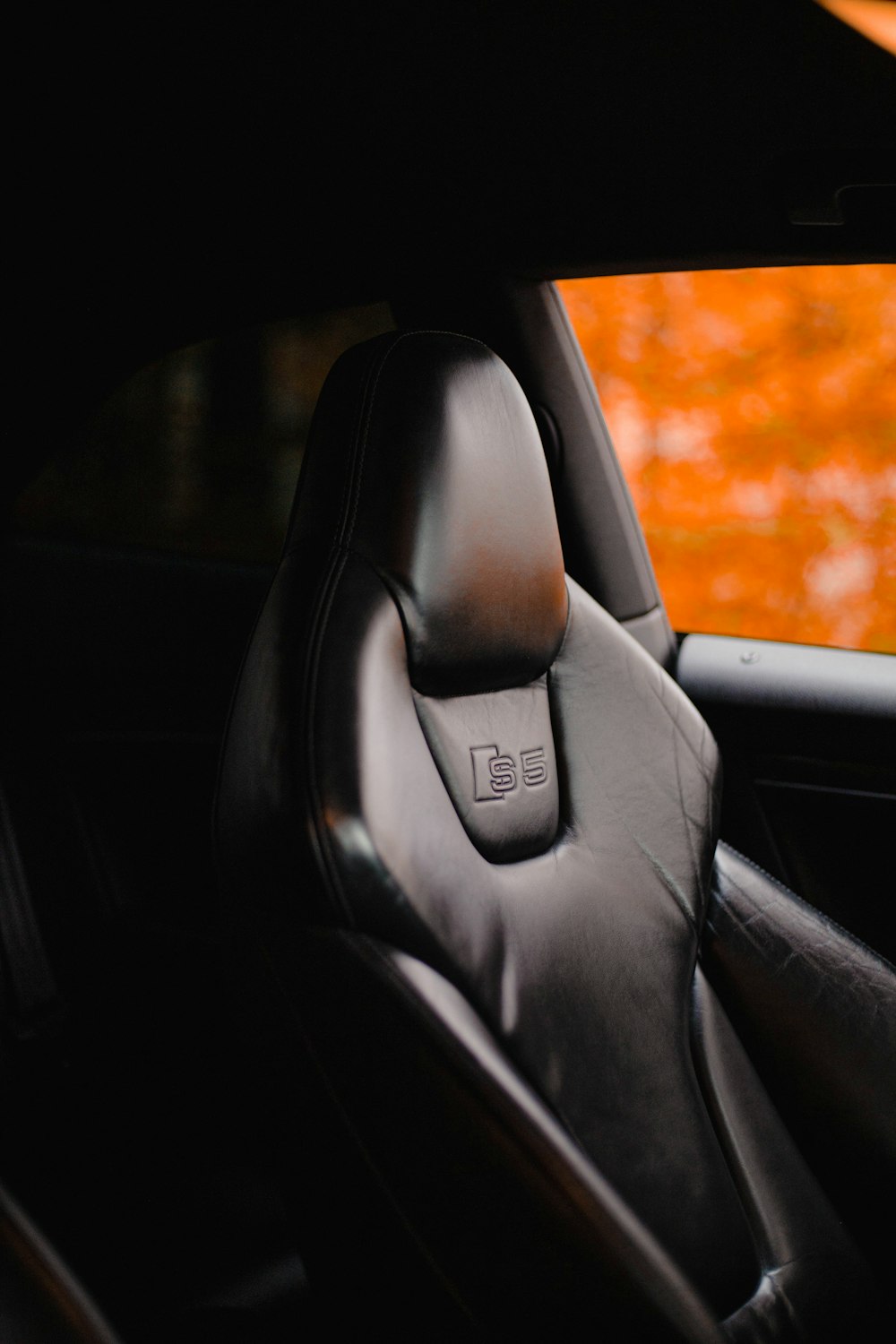 the interior of a car with a black leather seat