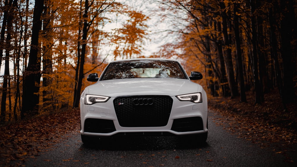 a white car parked on the side of a road