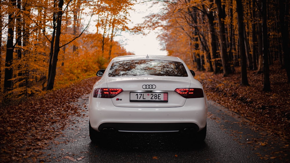 a white car parked on the side of a road