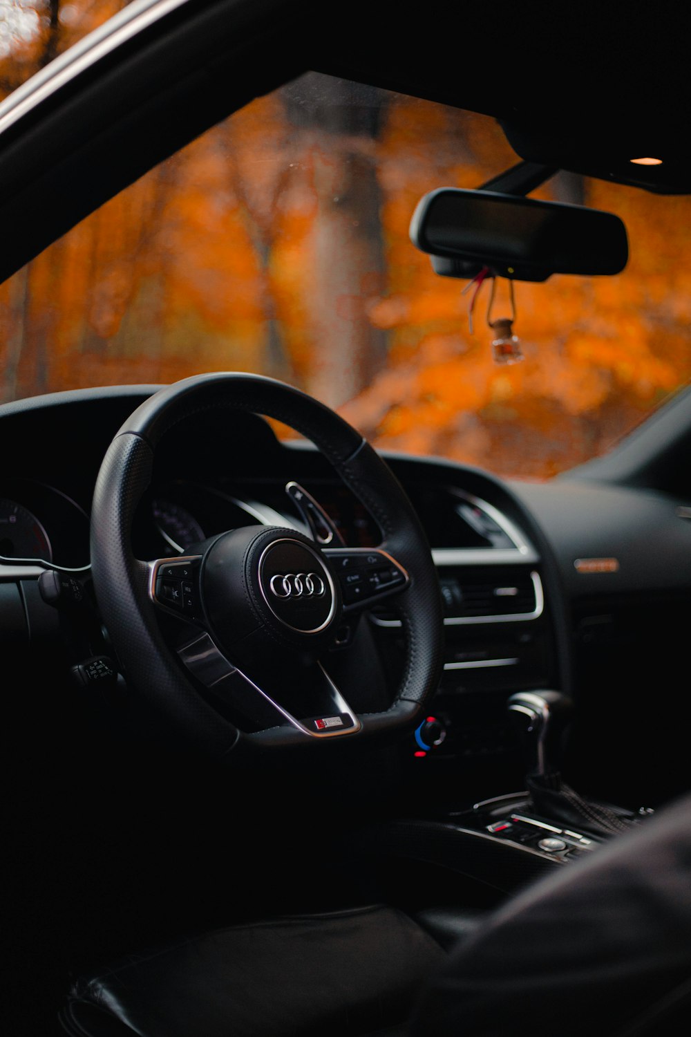 the interior of a car with a steering wheel and dashboard