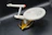 Close-up of a detailed collectible spaceship model from Escalapop displayed on a wooden shelf.