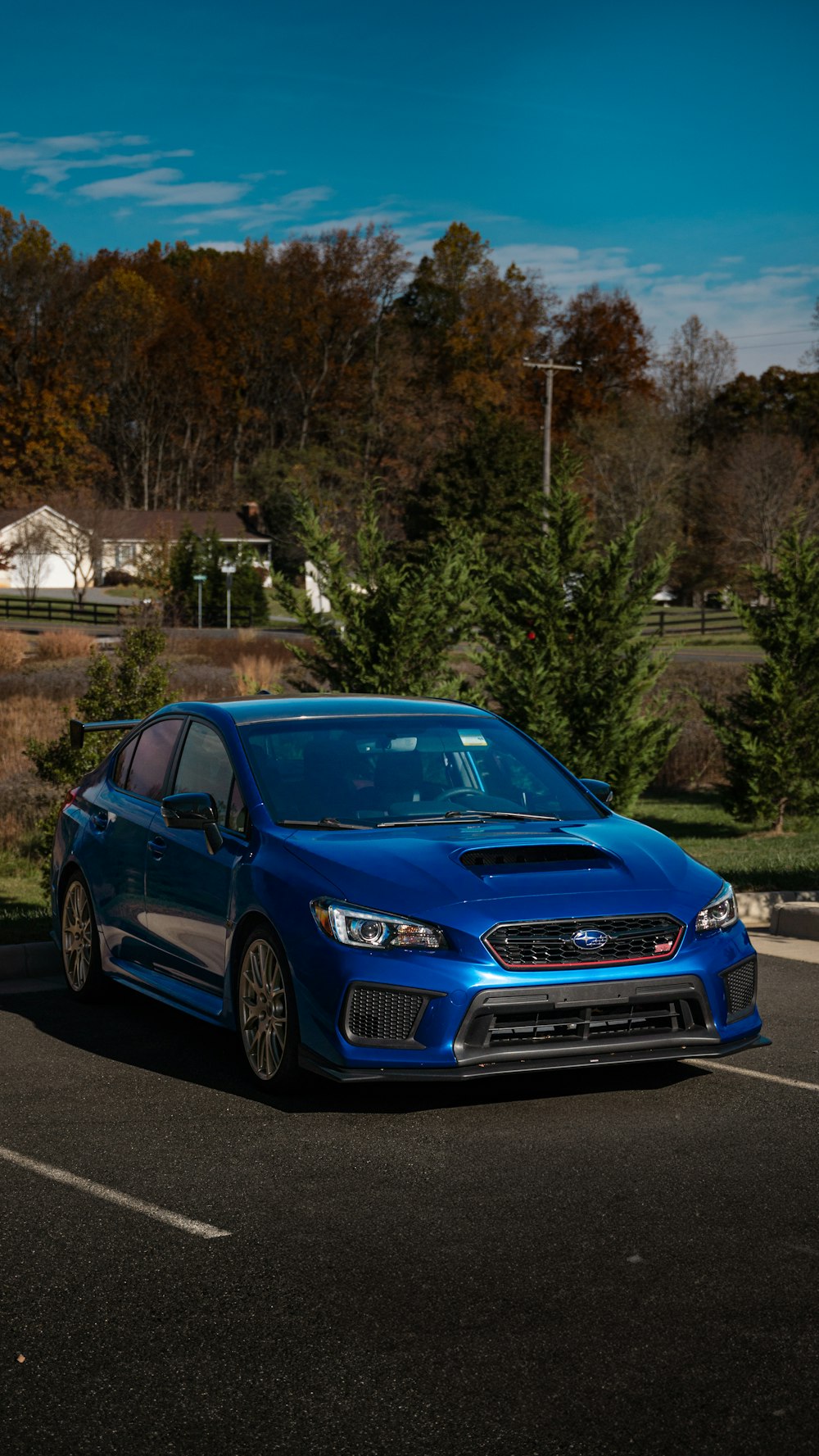 a blue car parked in a parking lot