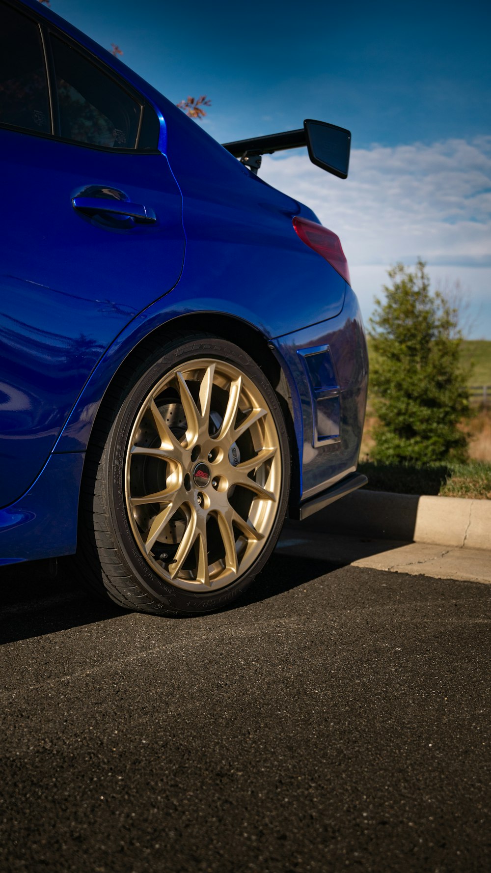 a blue car parked on the side of the road