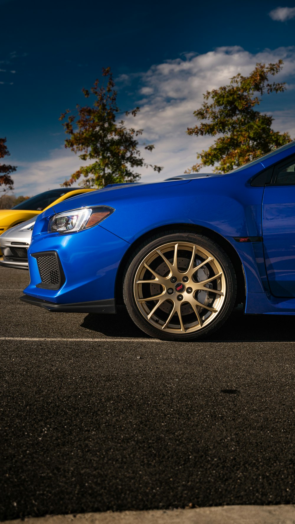 a blue sports car parked in a parking lot