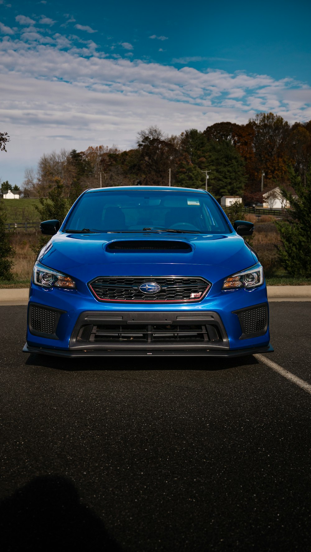 a blue car parked in a parking lot