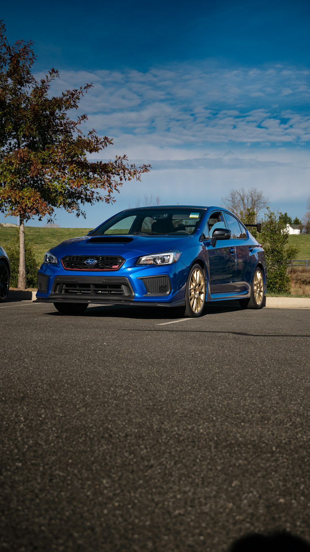 a blue car parked on the side of the road