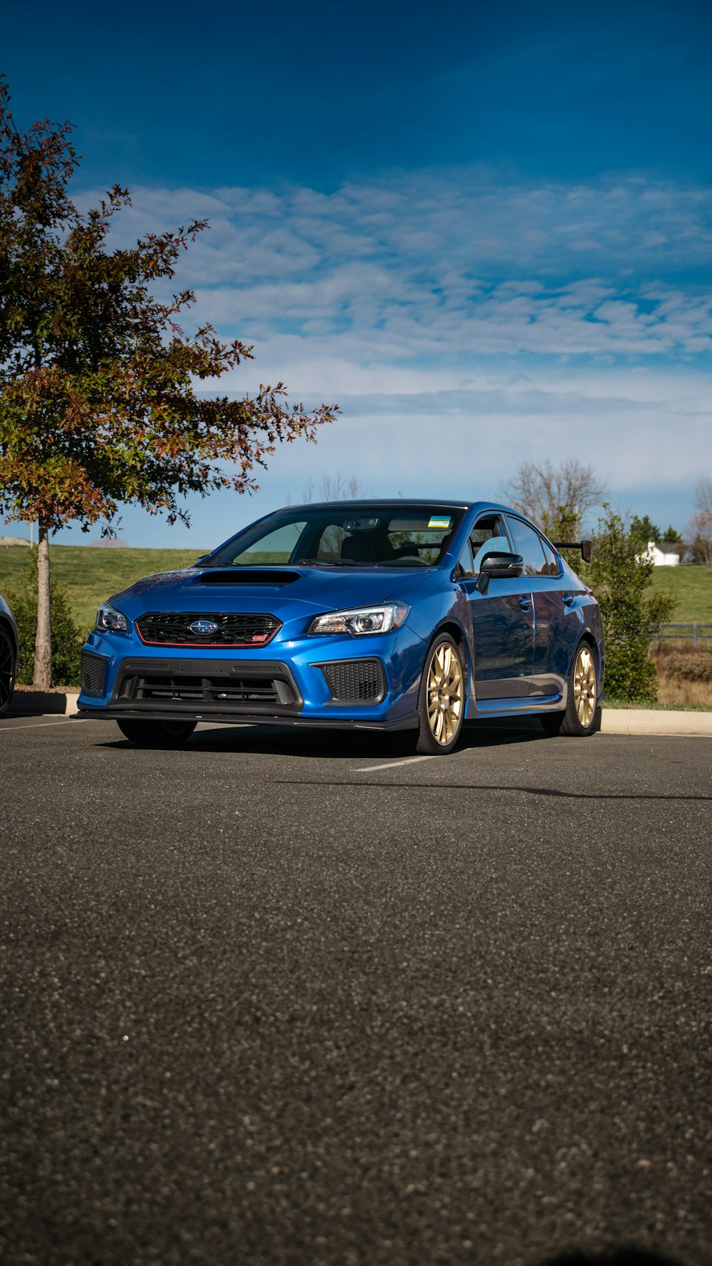 a blue subarunt parked on the side of the road