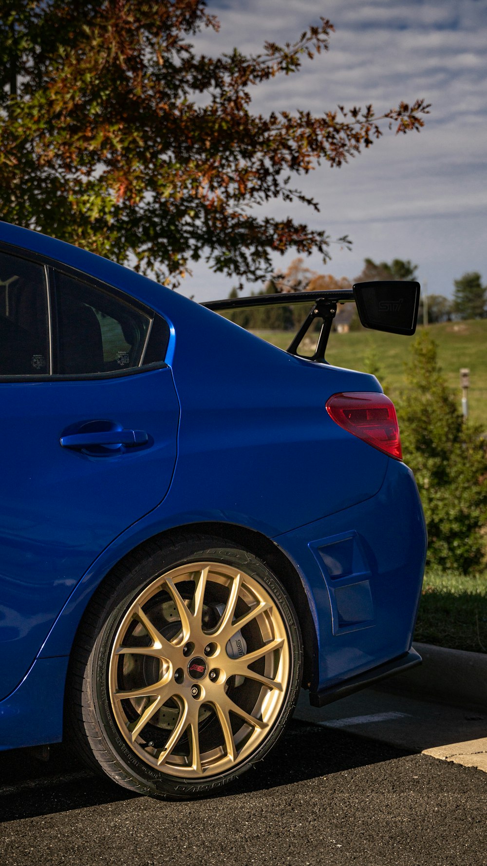 a blue car parked in a parking lot