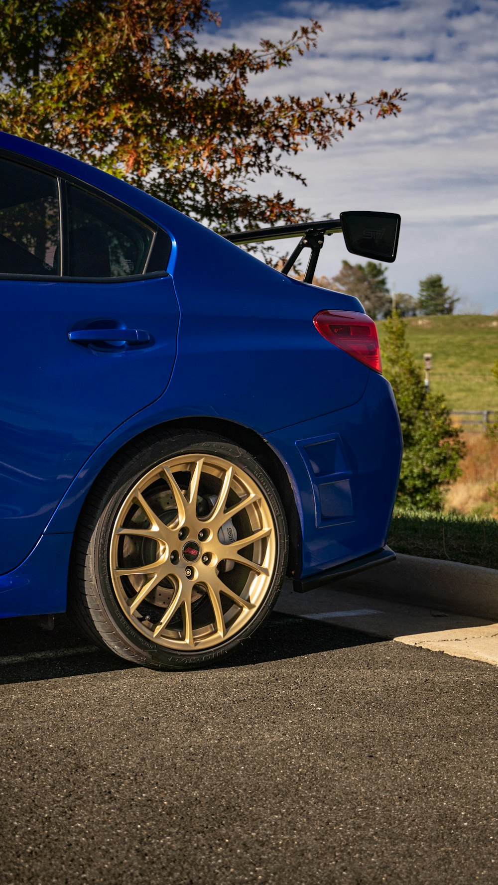 a blue car parked on the side of the road