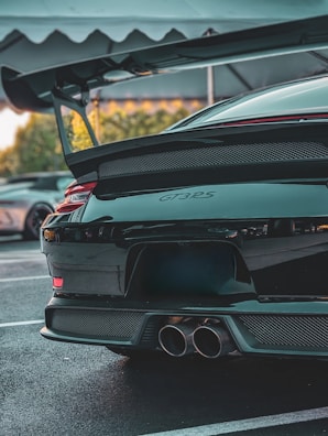 Rear view of a car with a custom spoiler and exhaust system.