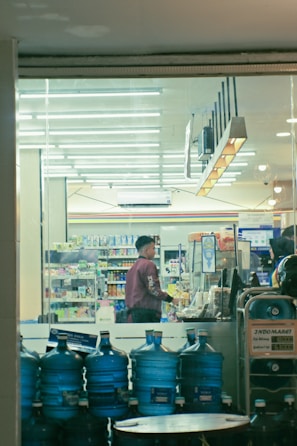 Happy customers filling their bottles at the refilling station.