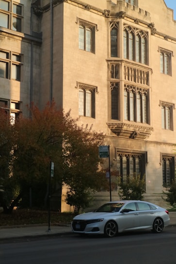 a car parked in front of a large building