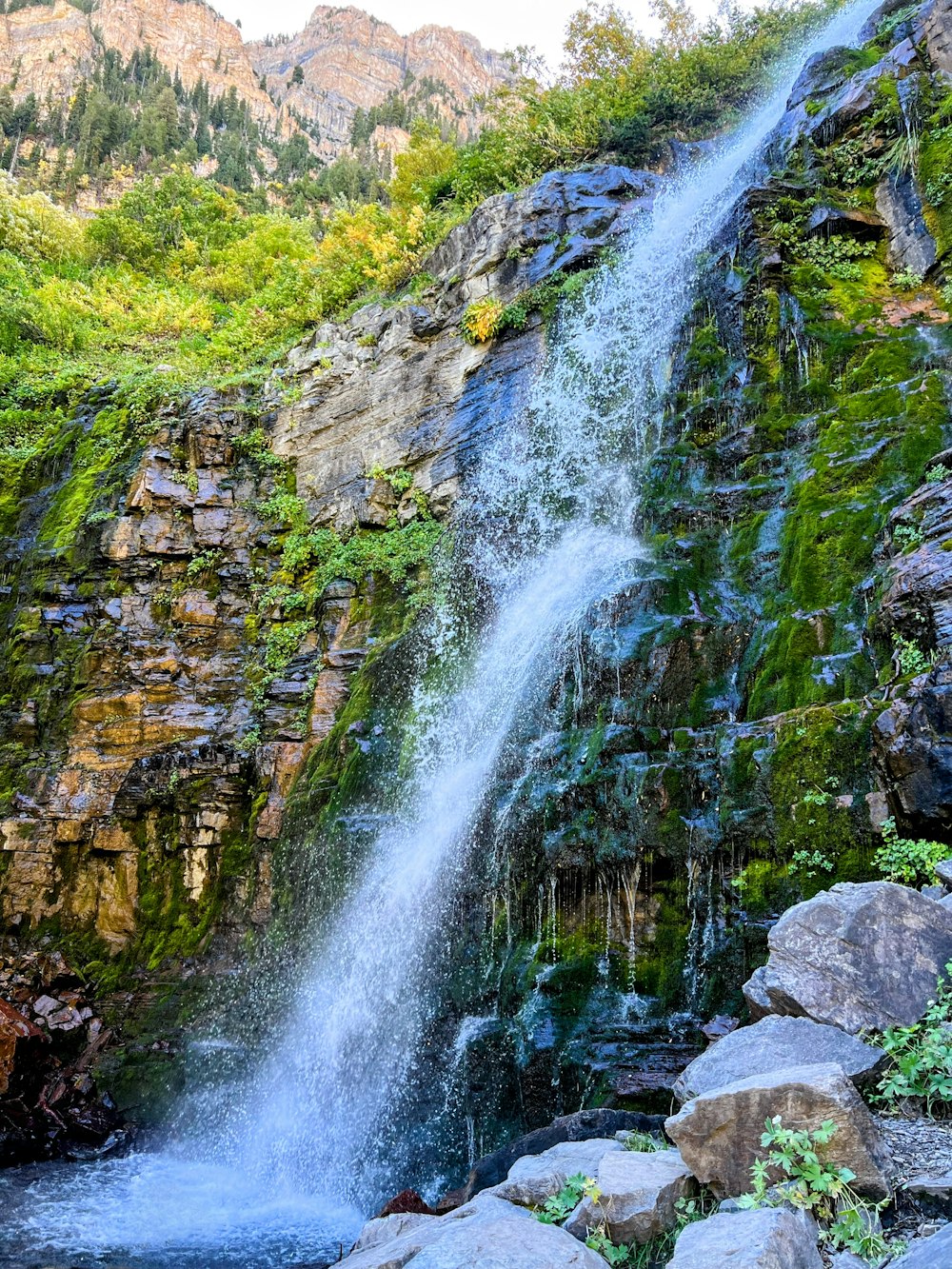a large waterfall with water cascading down it's side