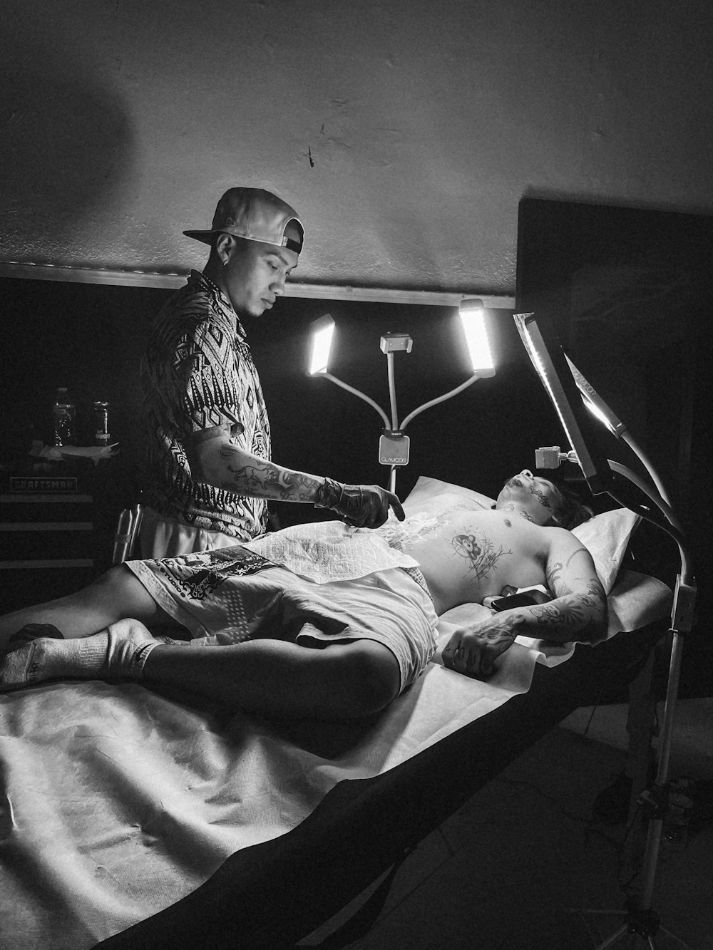 a black and white photo of a man laying in a hospital bed