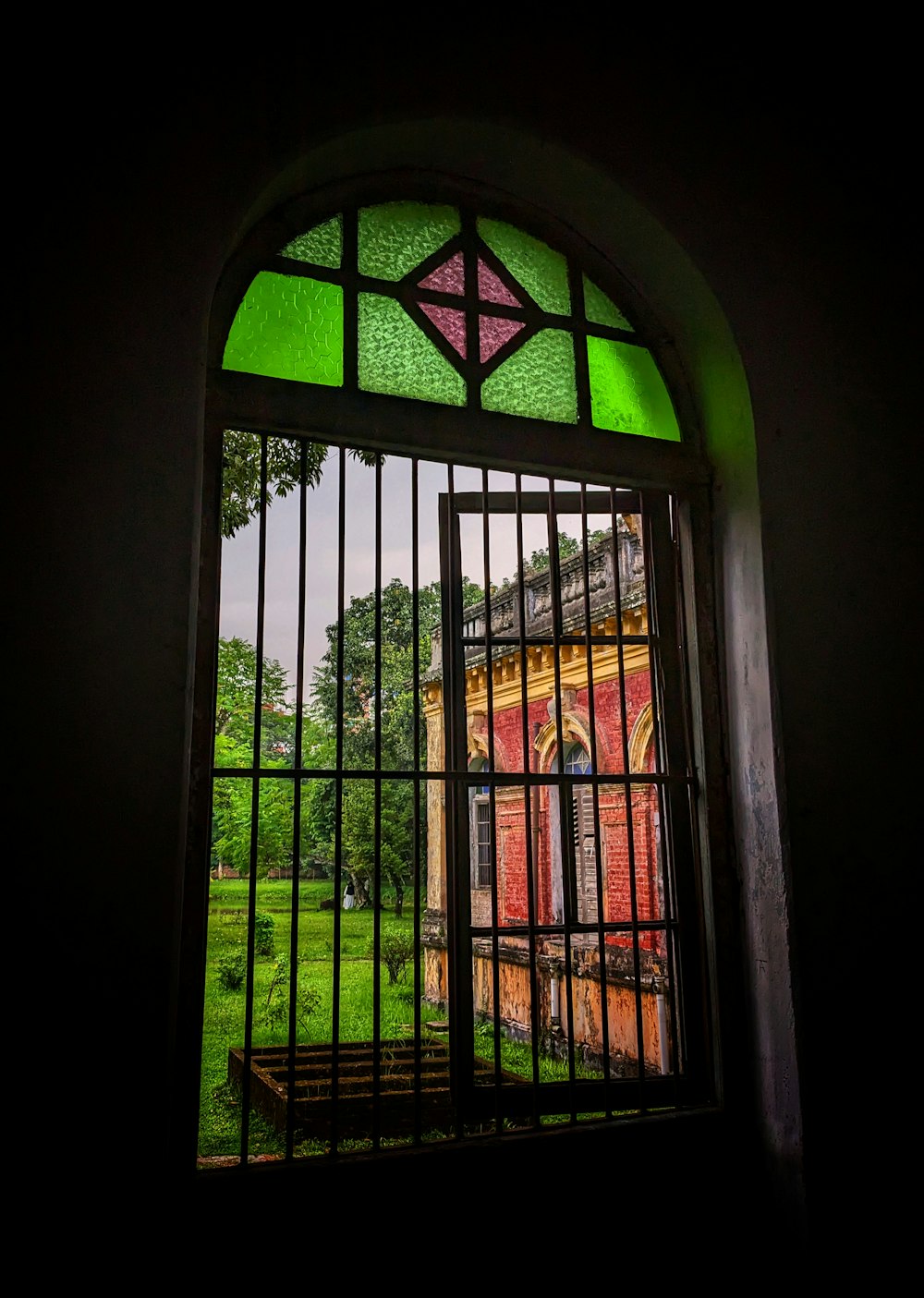 a stained glass window with a view of a building