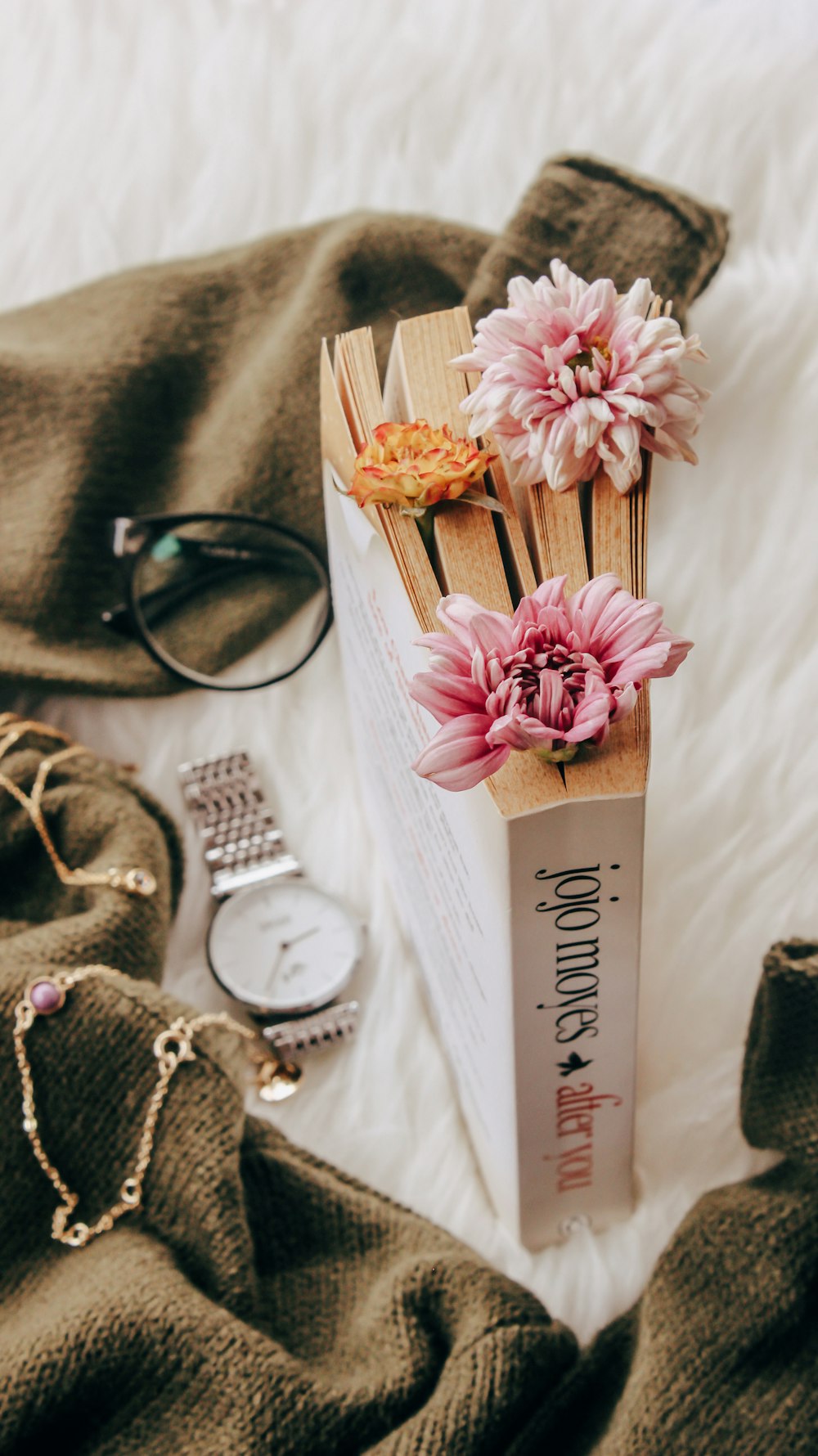 a book with pink flowers on top of it