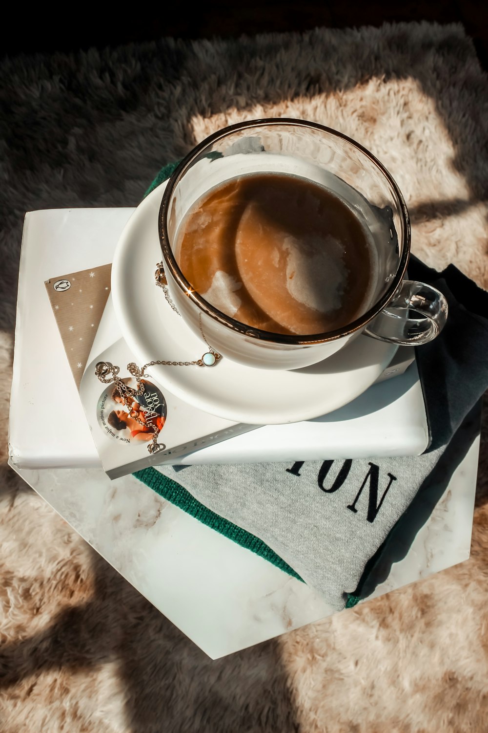 a cup of coffee sitting on top of a white plate