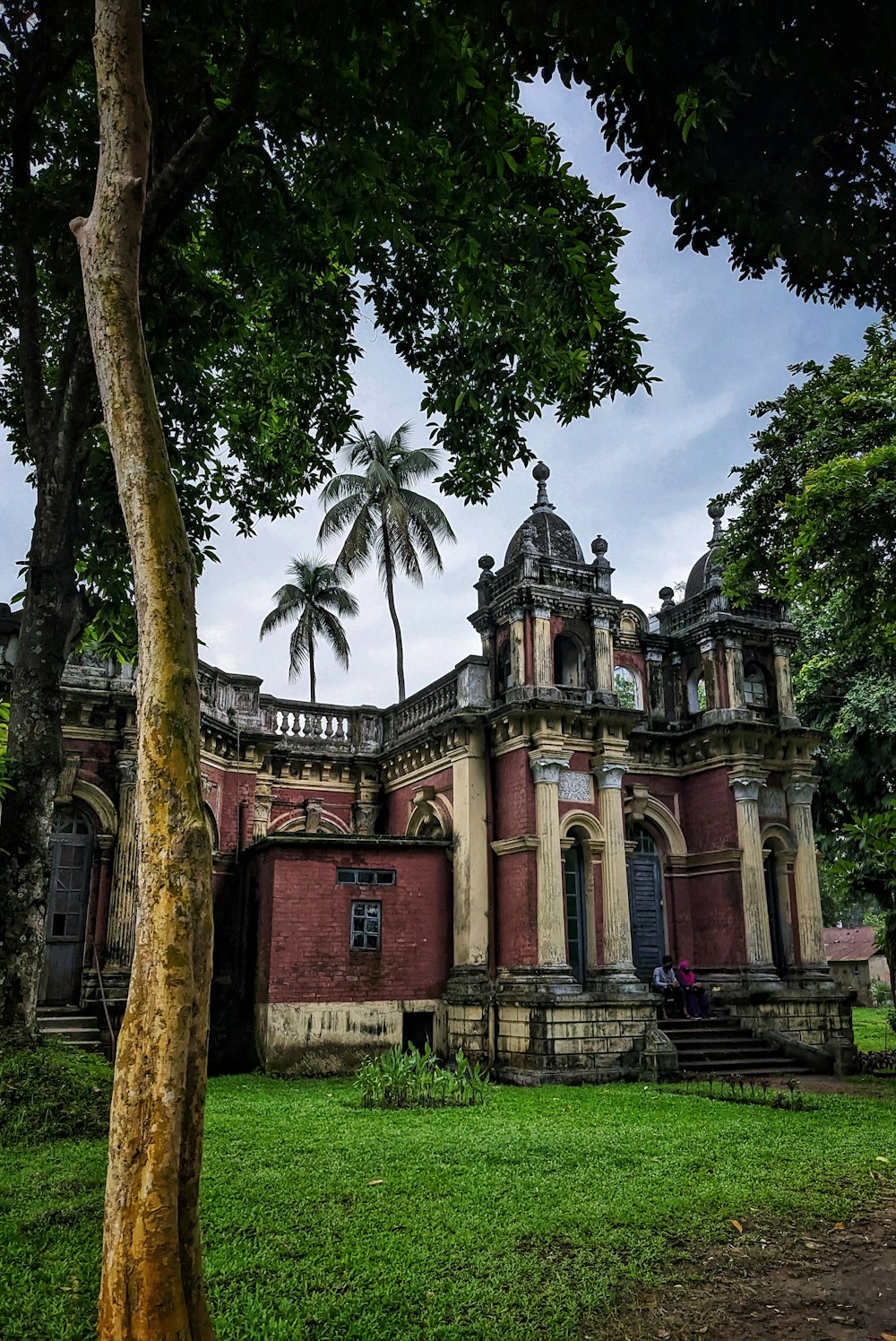 an old building with a tree in front of it