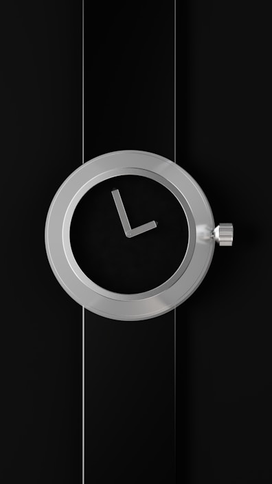 A sleek decorative wall clock with metal accents mounted on a modern living room wall.