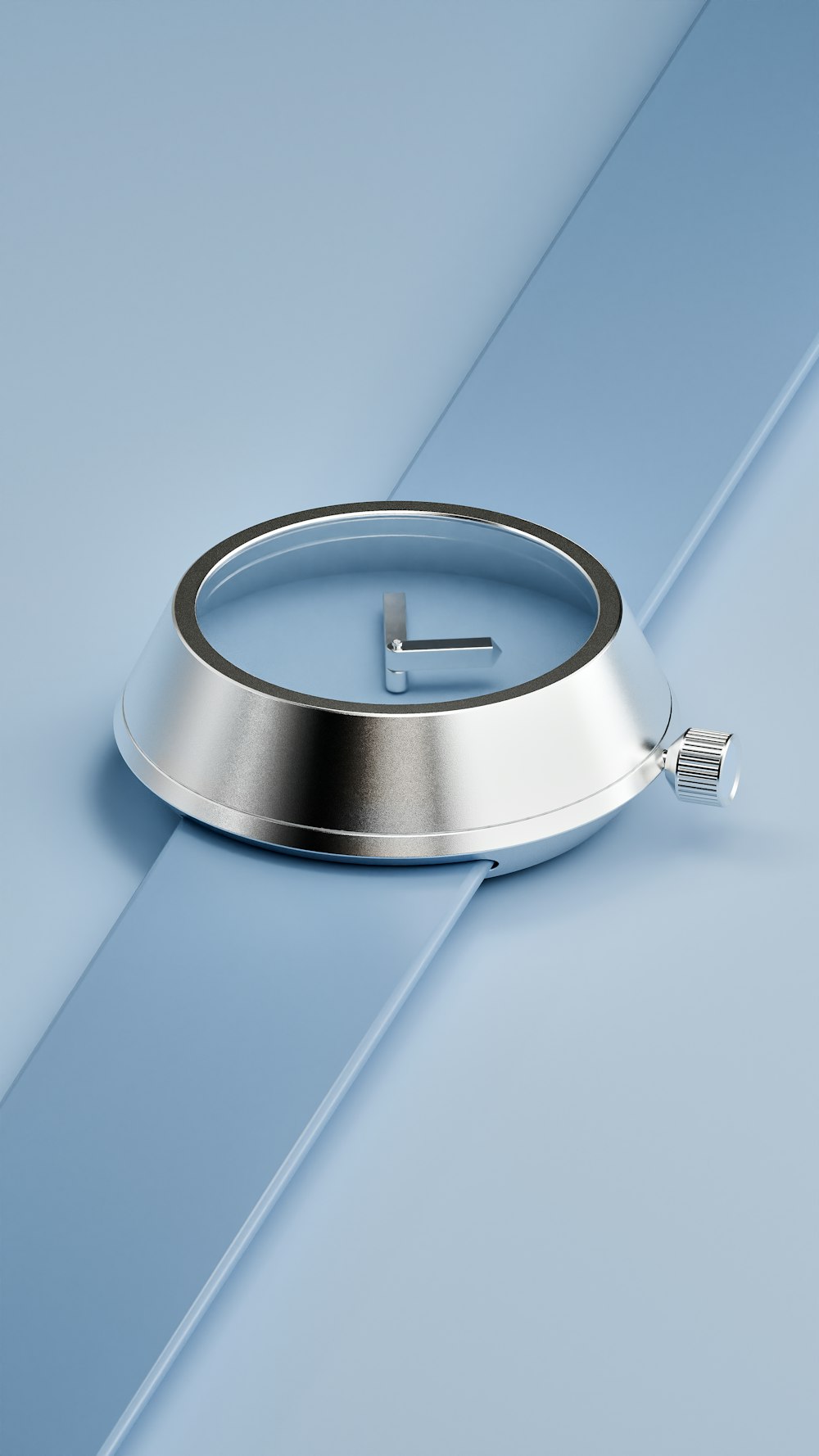 a silver clock sitting on top of a blue surface