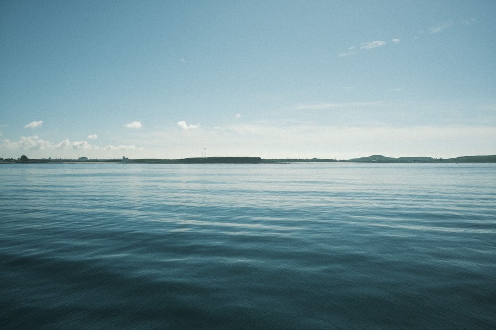 a large body of water with a small island in the distance