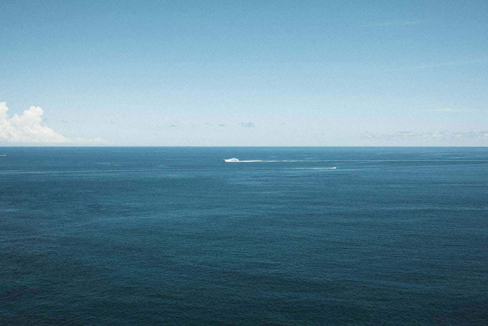 a boat out in the ocean on a sunny day