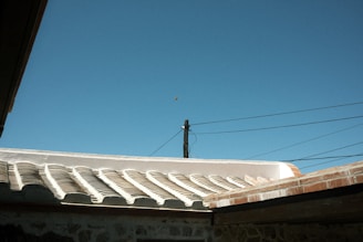 the roof of a building with a blue sky in the background
