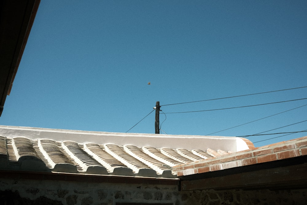 the roof of a building with a blue sky in the background