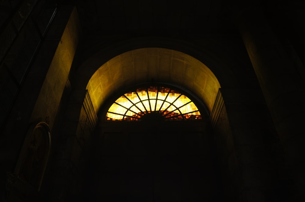 a window in a building with a bright light coming through it