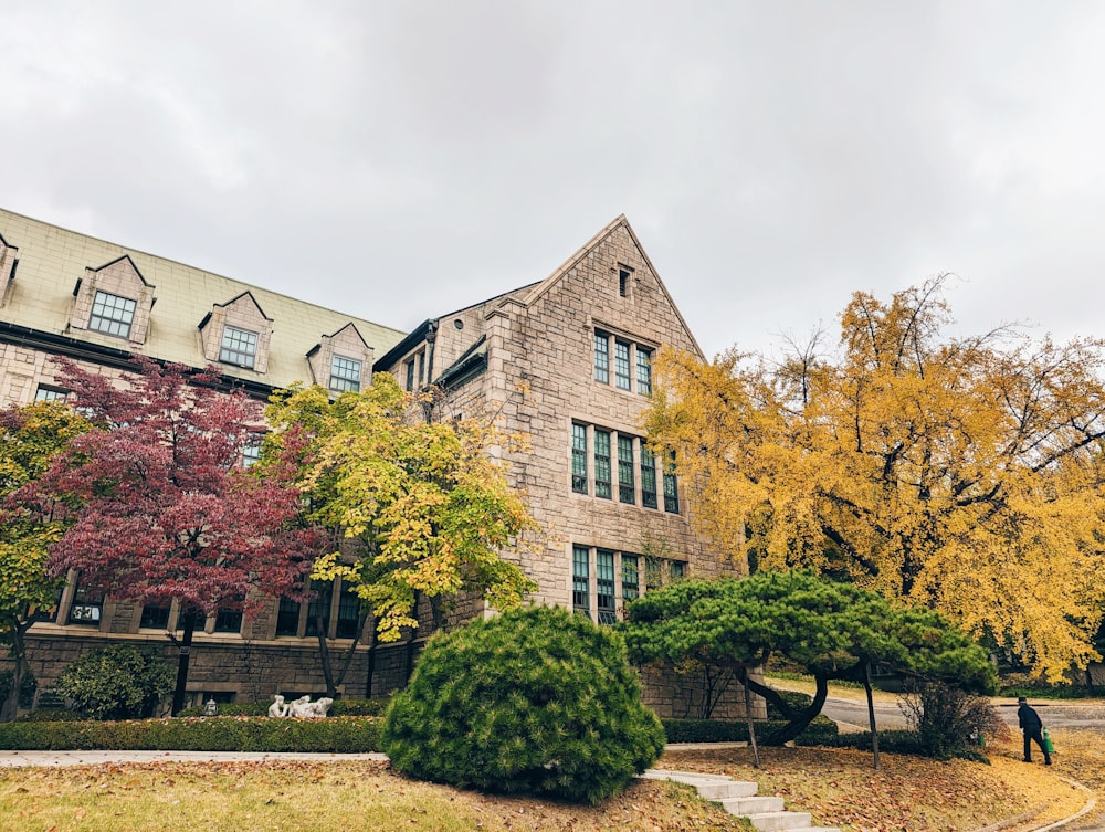 a large brick building with trees in front of it