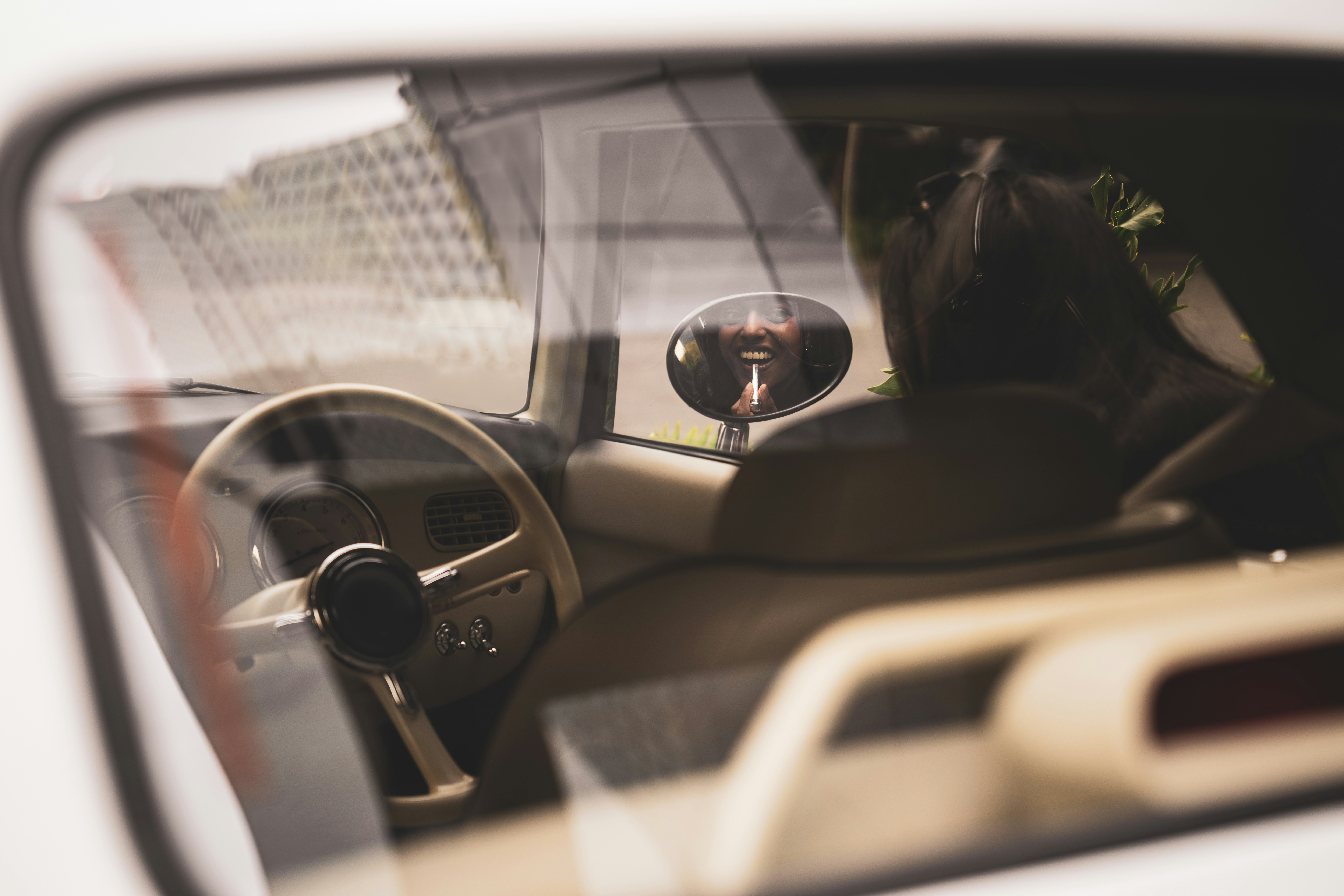 a reflection of a person in a car's side view mirror