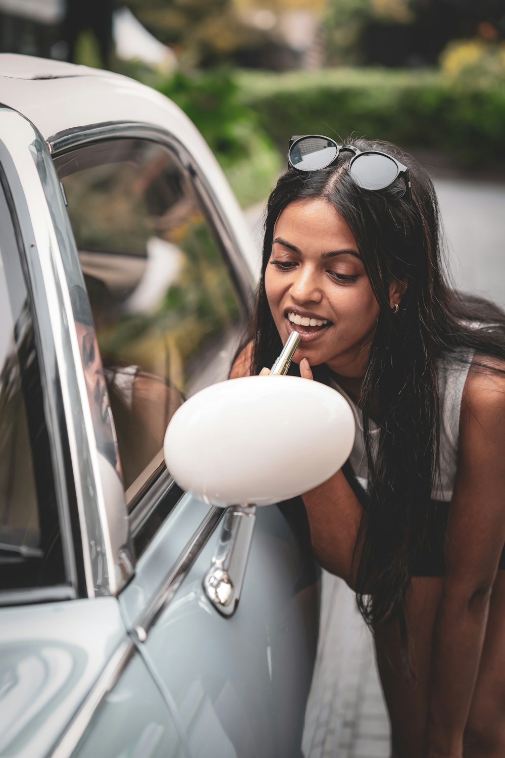 a woman leaning out of a car window smoking a cigarette