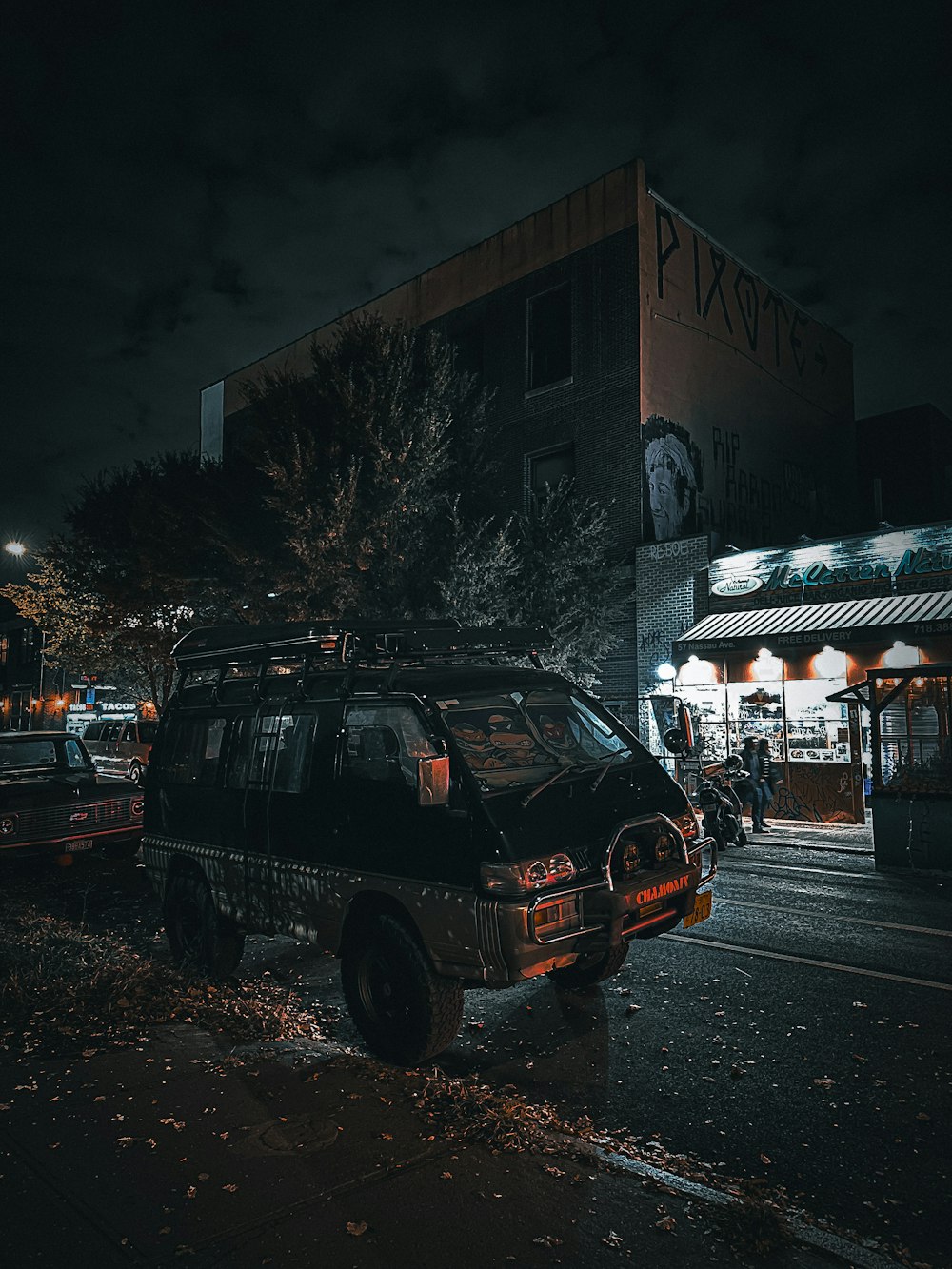 a van parked on the side of the road at night